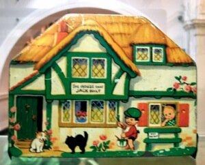 old vintage tin of a house